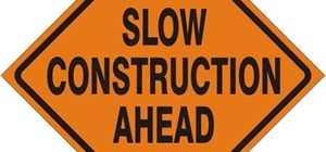 Slow! Construction Ahead. Sign